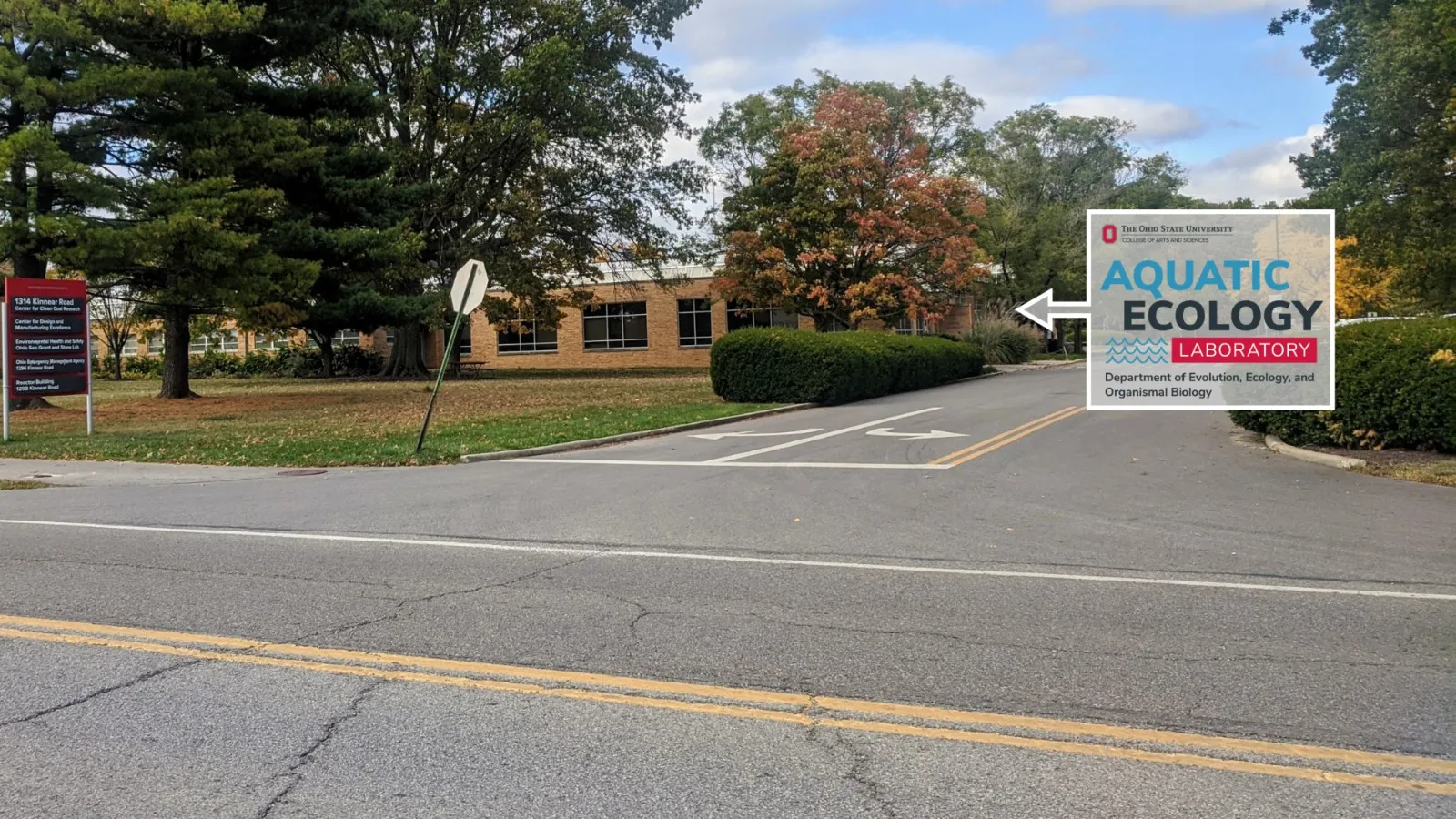 The Research Center building viewed from Kinnear Rd with the AEL logo in a arrow box pointing toward the building.
