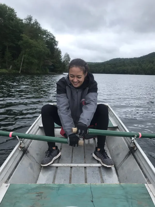 Demetra rowing a rowboat in a lake